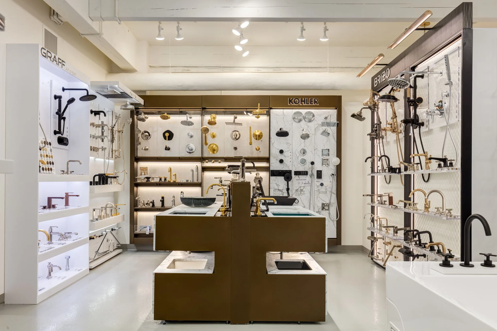 Faucet and shower fixture display wall at the Baths by Design showroom