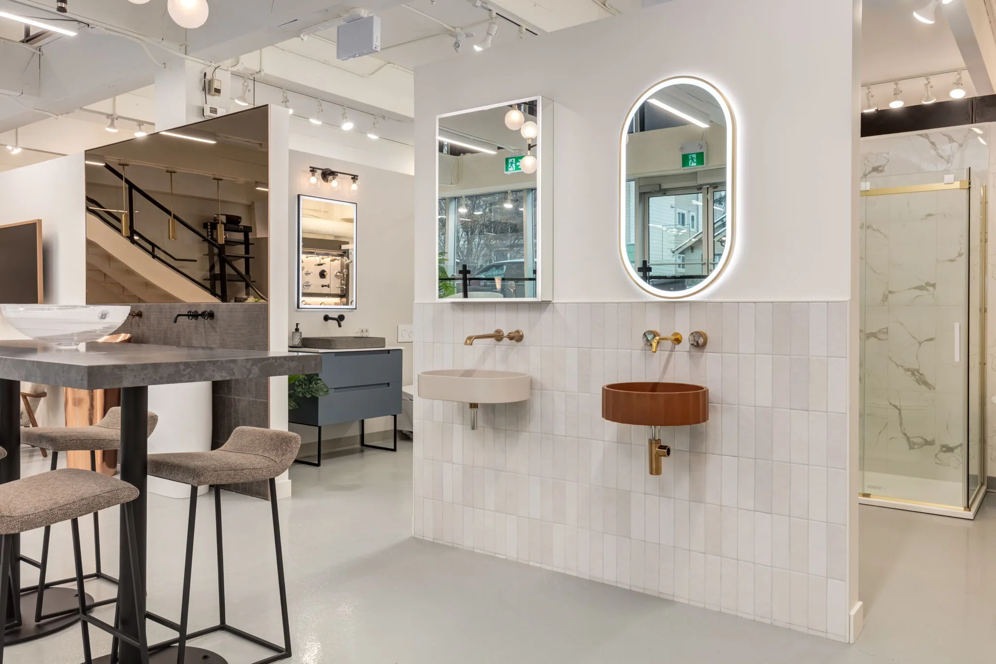 Baths by Design showroom with a wall-mounted vessel sink and LED mirror