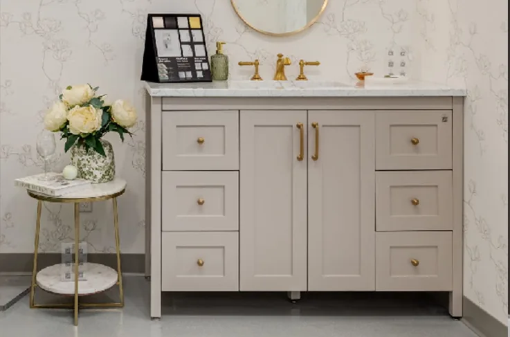 Bathroom vanity with marble top, brass faucet and round mirror