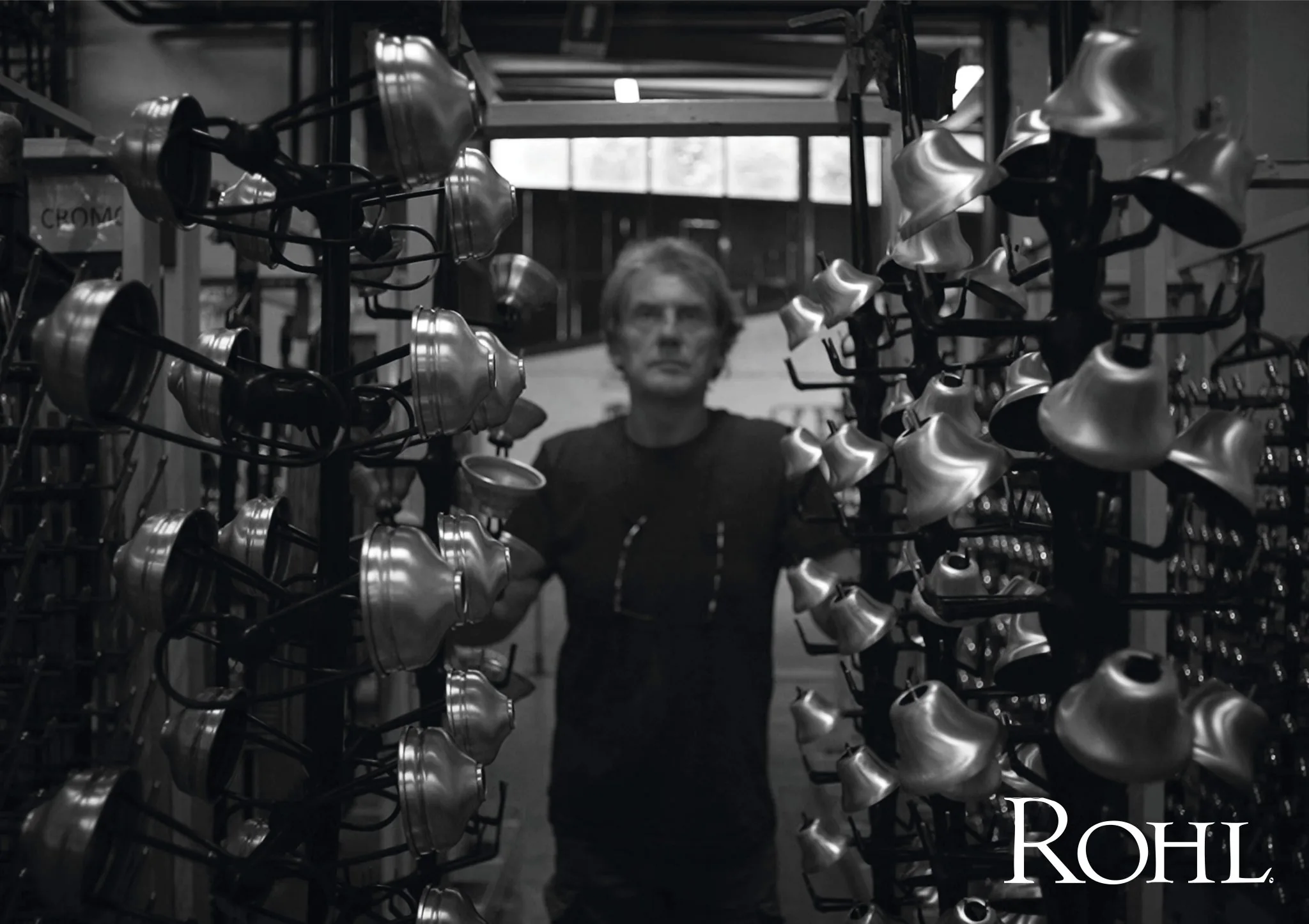 ROHL artisan among rows of faucets in the manufacturing workshop