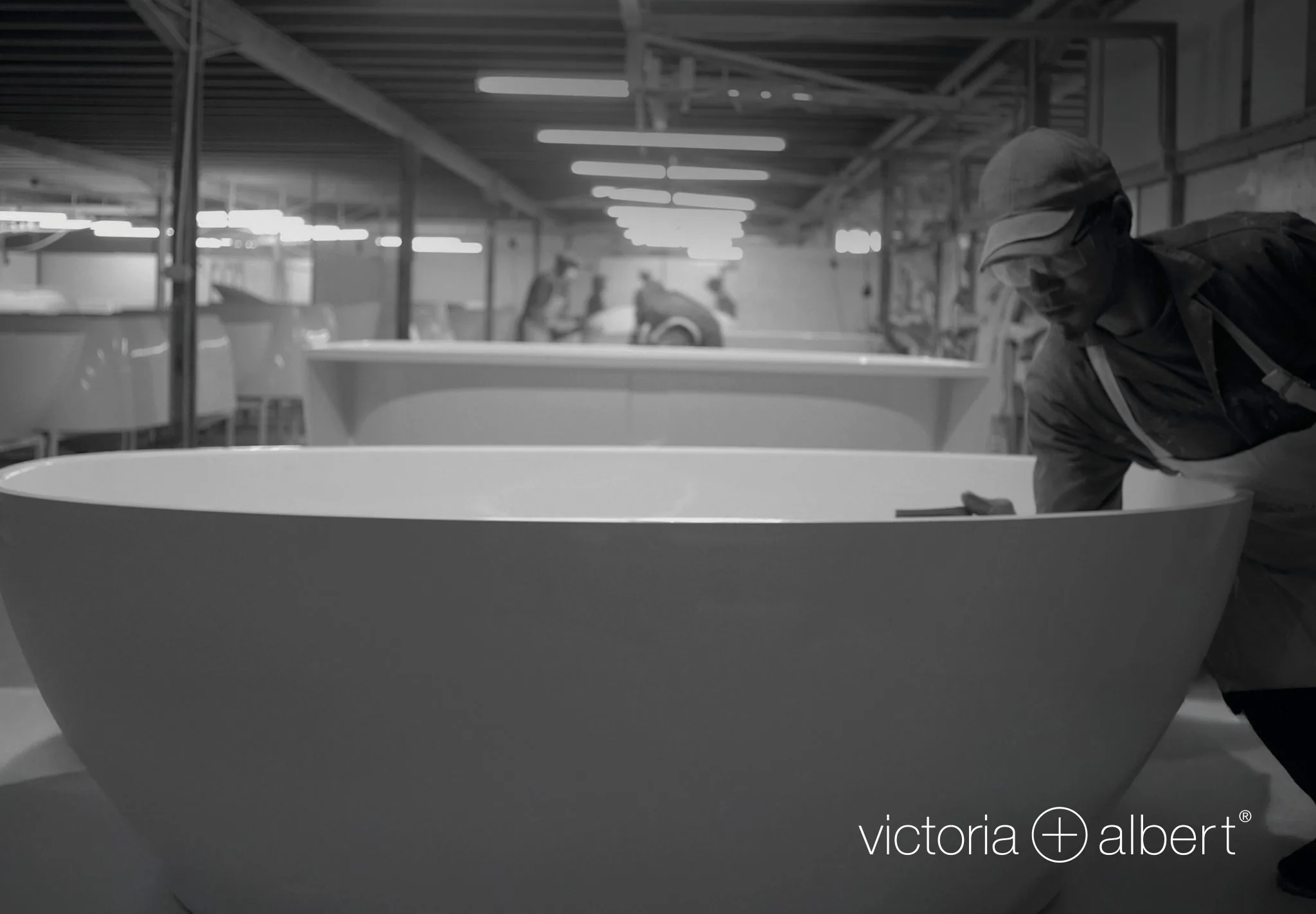 Victoria + Albert artisan hand-finishing a freestanding bathtub in the workshop